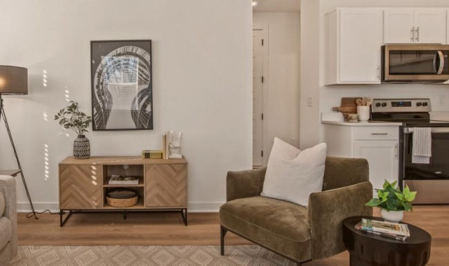 The essence of exceptional living Furnished living room with a couch and a table in townhome at The Harris