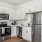 Modern townhome kitchens with white cabinets and stainless steel appliances at The Harris