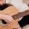 Lifestyle photo of a person playing a guitar