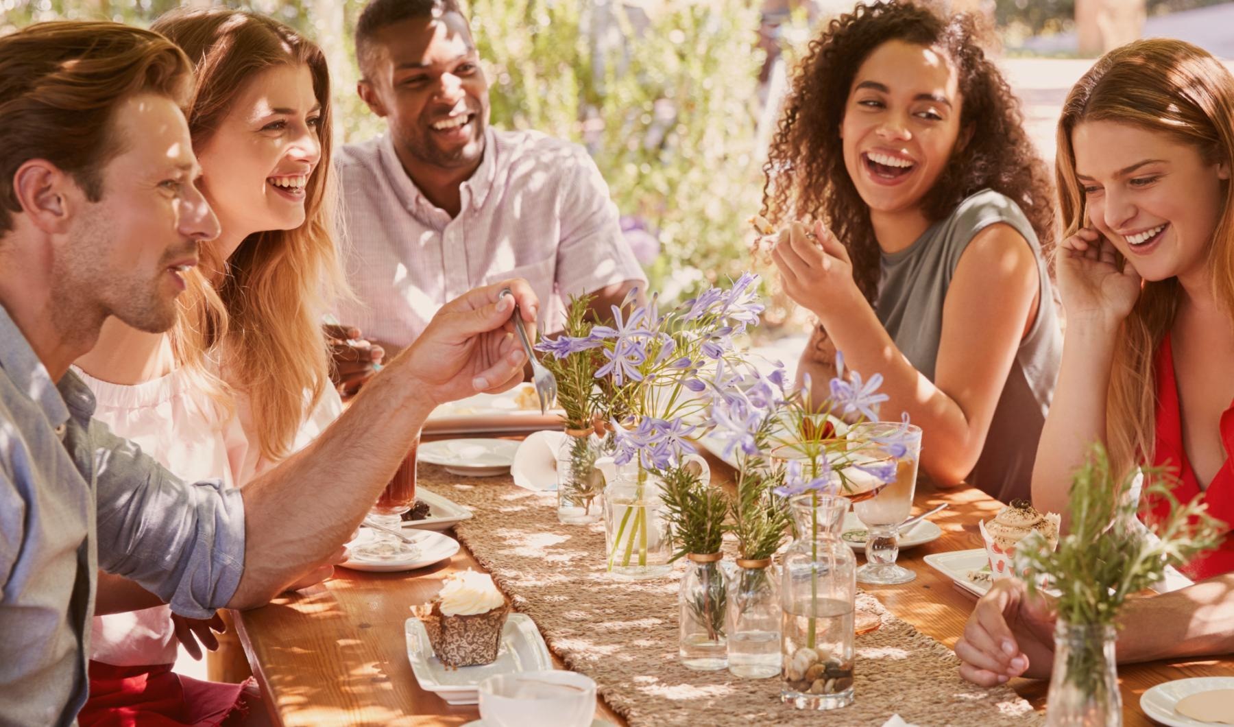 Vibrant community life with a variety of dining options Lifestyle photo of a group of people sitting around a table with food and drinks