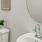 Modern half-bathroom with a mirror and sink in townhomes at The Harris